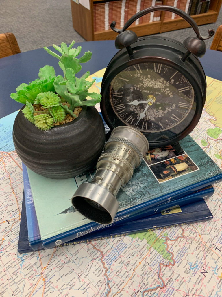 a vintage clock, succulent and a stack of books at a teacher retirement party theme