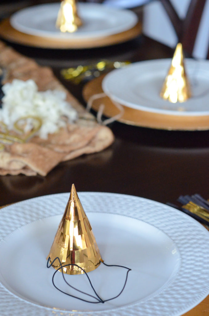gold and white table setting for New Years Eve baby shower 