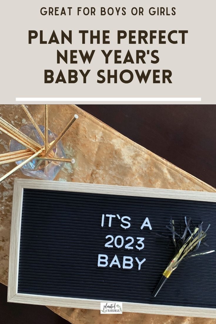 New Year's baby shower letter board on gold table runner for baby shower themes for winter