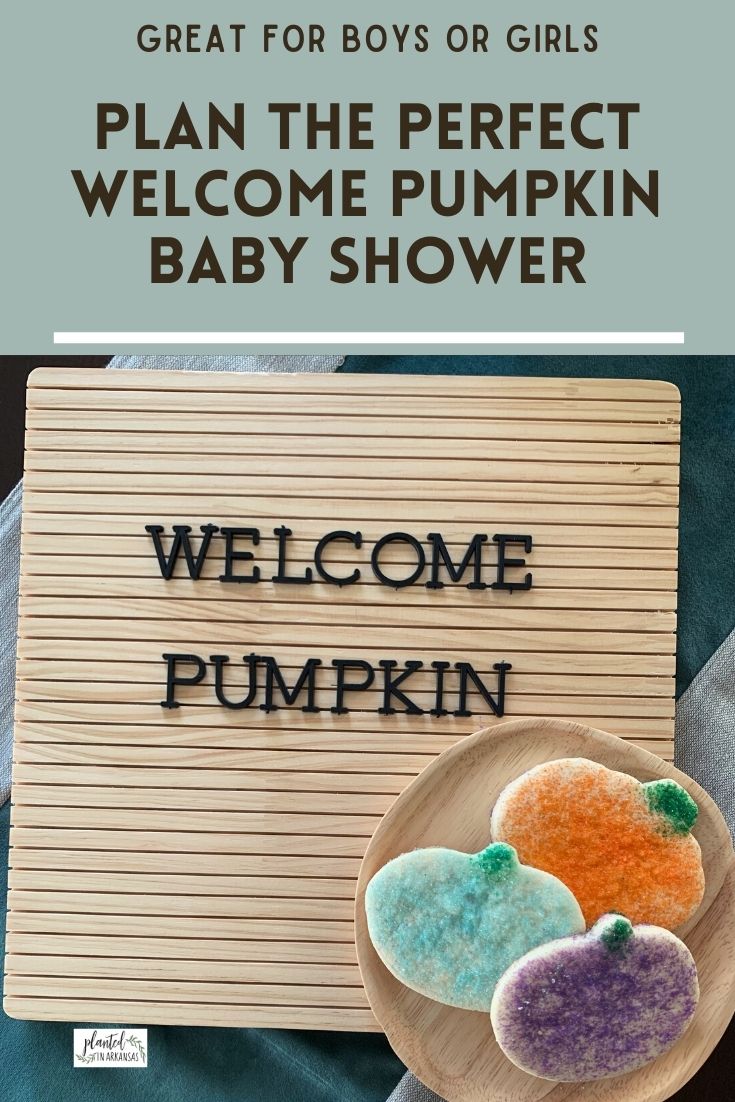 welcome pumpkin baby shower phrase on wood letter board with three pumpkin sugar cookies 