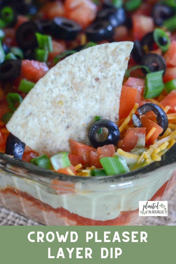 Amazing Mexican layer dip with chip tucked in top