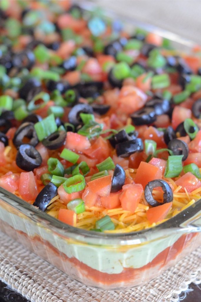 cold layered taco dip in glass container