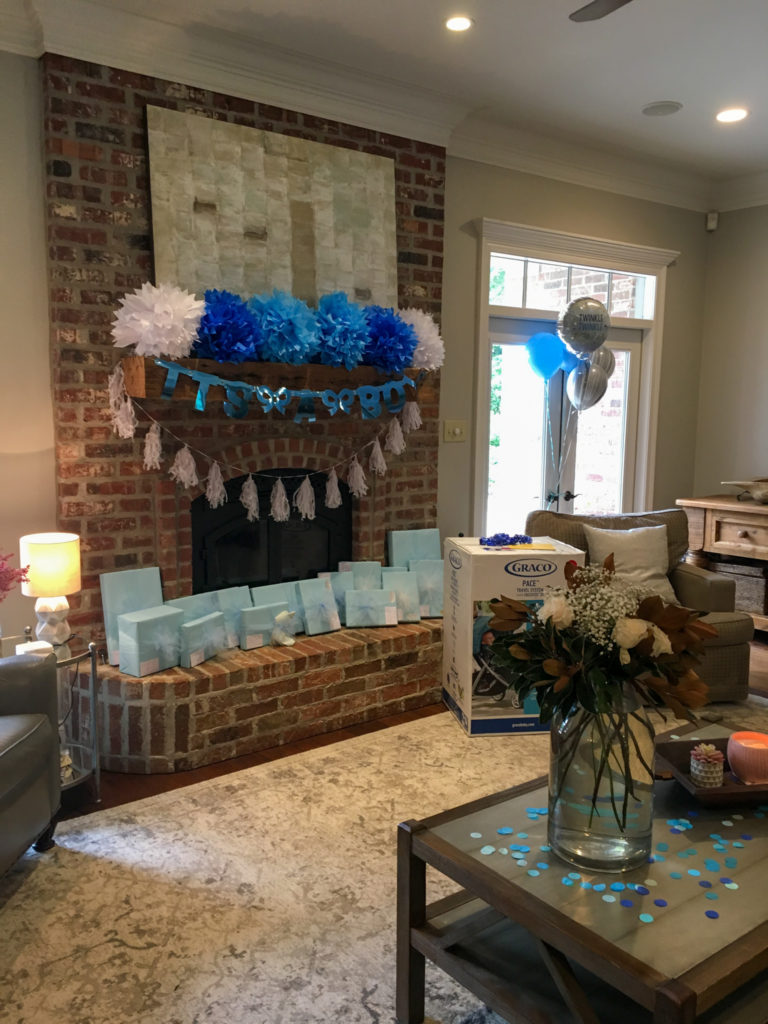 blue baby shower decorations on a mantle area at a simple blue baby shower