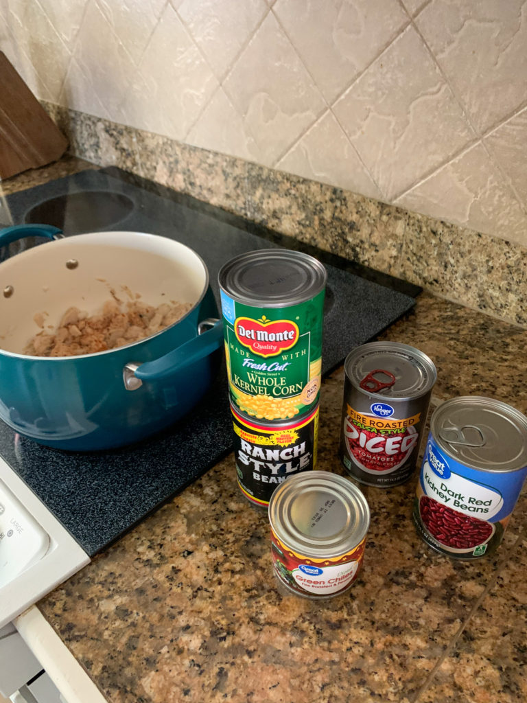pot of chopped meat with cans on counter southwest soup with white meat