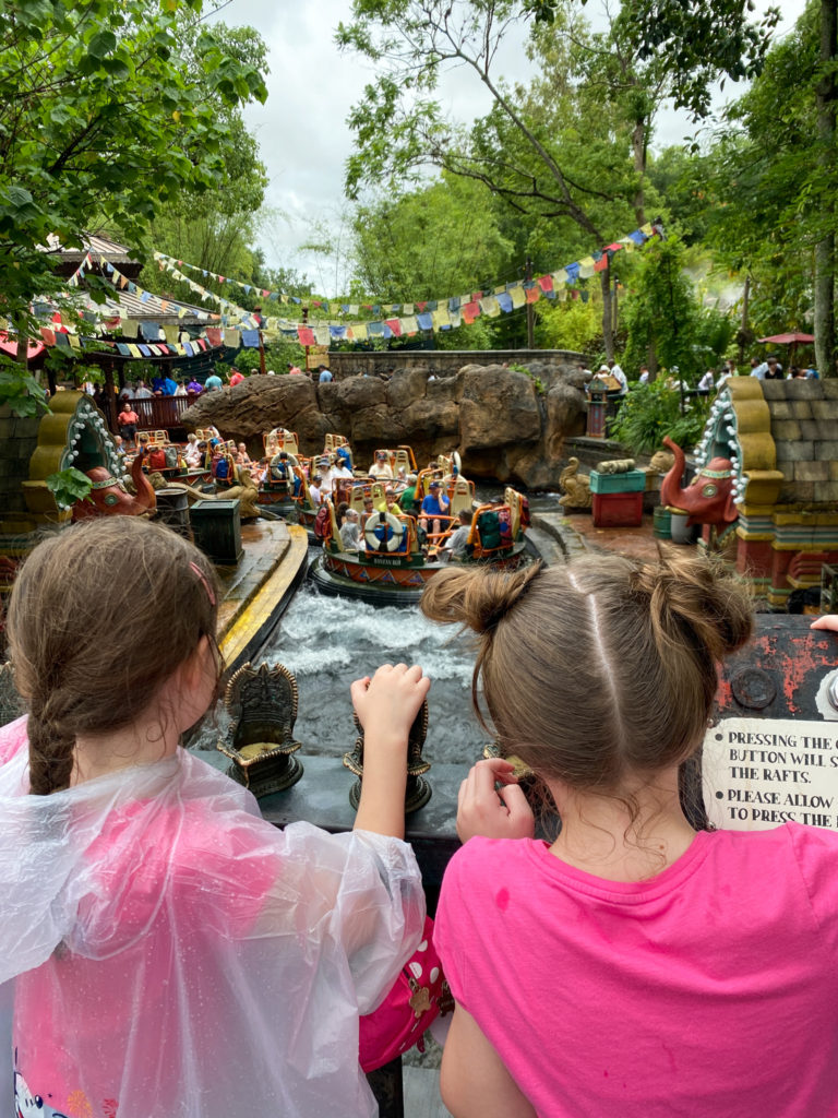 two girls pressing the button on the raft ride at Animal Kingdom during a 7 day Disney World itinerary
