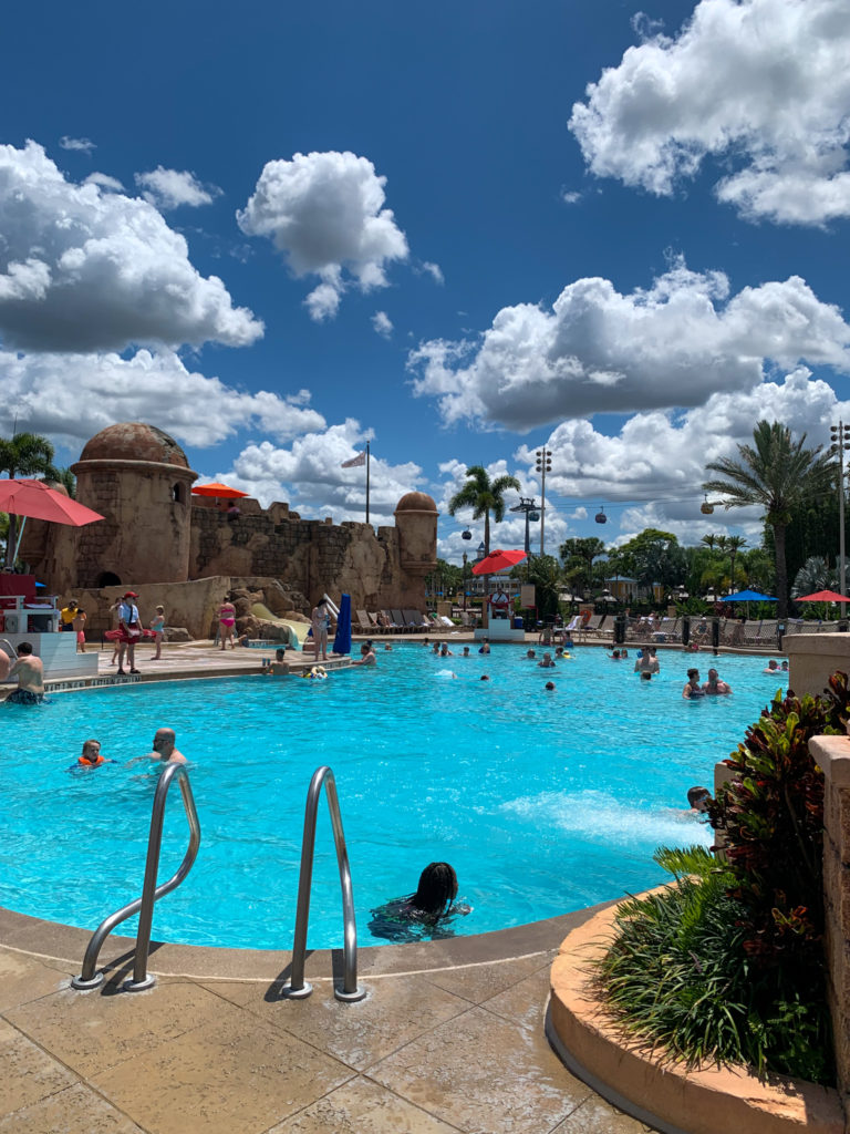 Disney Caribbean Beach Resort pool on sunny day with clouds