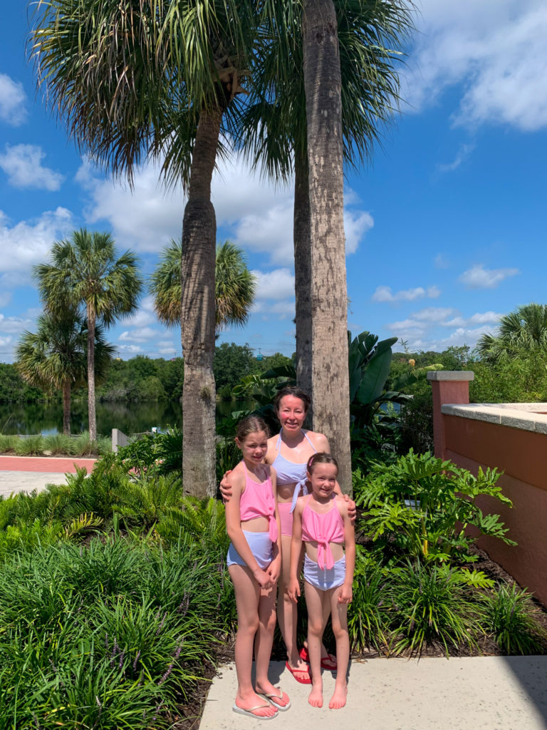 mom and girls wearing polka dot mommy and me swimsuits to show what to wear to Disney World