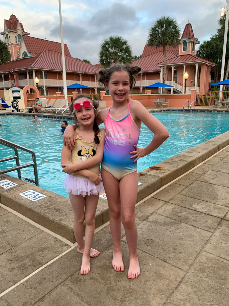 little girls in front of Caribbean Beach Resort pool