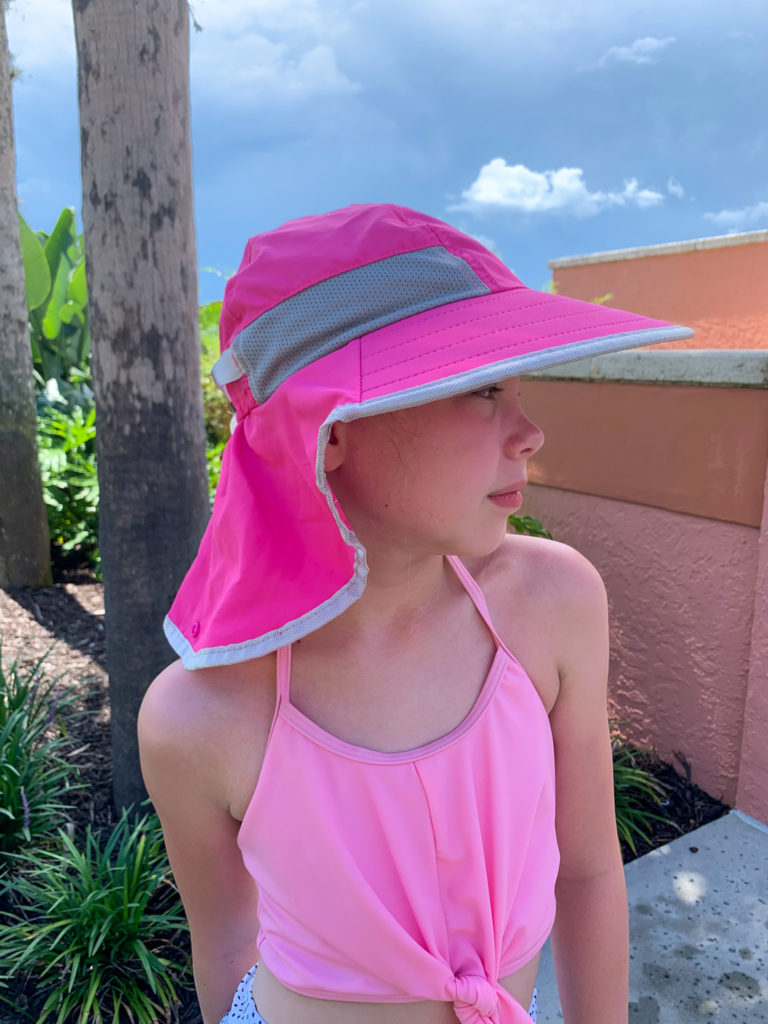 little girl with a hot pink sun hat
