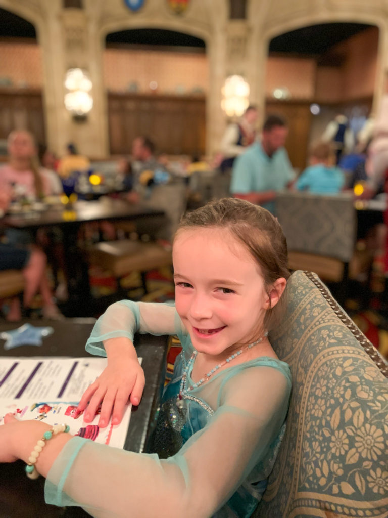 little girl in princess dress at Cinderella's Royal Table at Magic Kingdom 