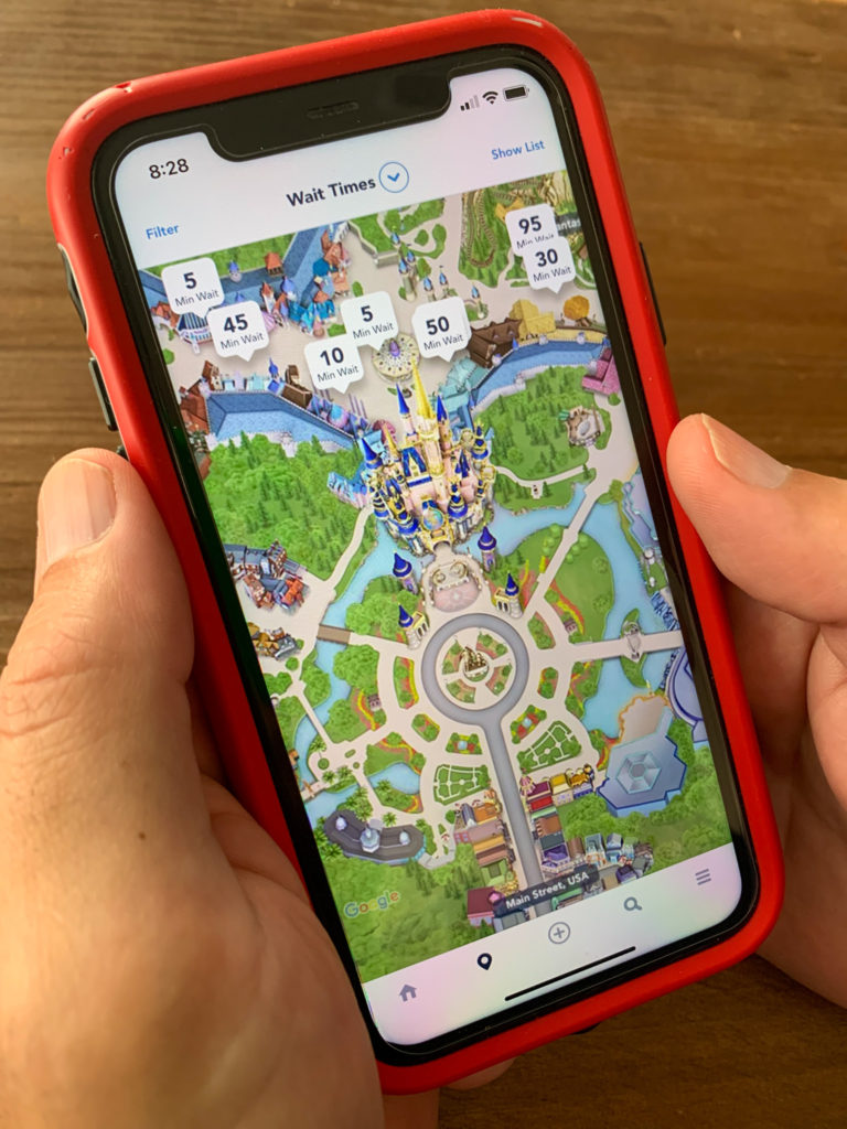 man using the My Disney Experience app to explain tips for a first time at Disney World