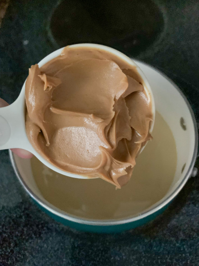 scoop of peanut butter to add to condensed milk glaze for peanut butter chocolate cake