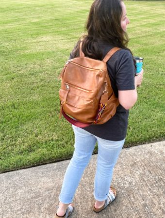teacher backpack on teacher's backpack as she walks