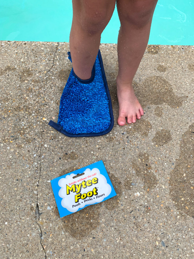 child tries on Mytee foot slipper for an idea for gifts for pool owners with pool in background