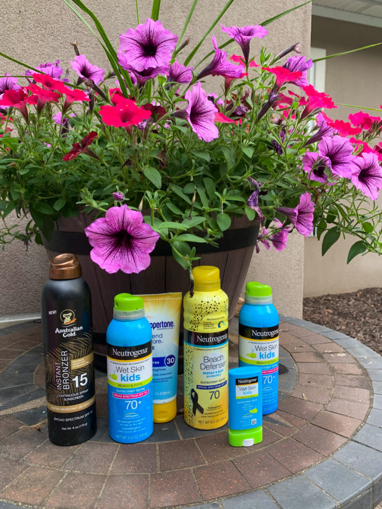 "pool cooling" gifts for pool owners ideas - group of sunscreen - in front of large pot of flowers