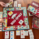 kids playing an Arkansas Razorback board game - Hogopoly and a Razorback puzzle