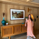 woman wearing gingham Charleston outfit in The Ryder Hotel common area