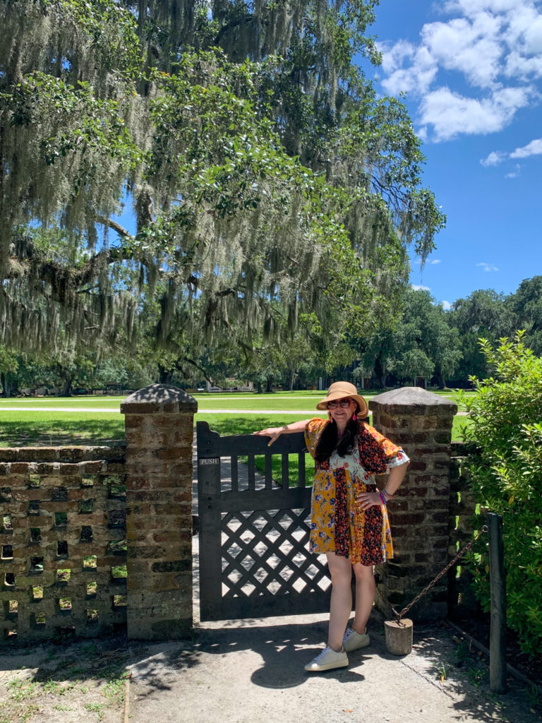 woman wears boho dress and sneakers at Middleton Place