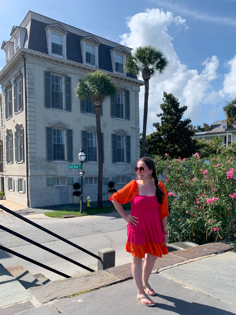 woman wears color block dress for a Charleston outfit as she stands in The Battery