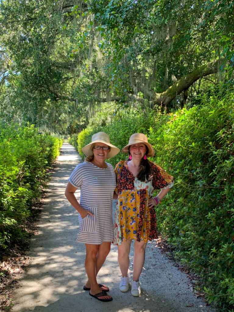 two ladies posting in Charleston outfits at Middleton Place