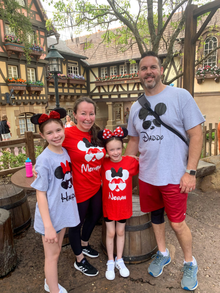 family in matching family Disney outfits at Magic Kingdom