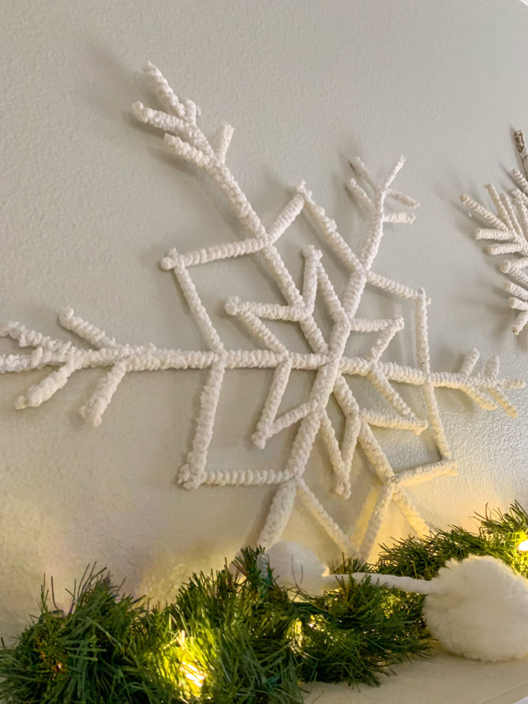 large white flocked snowflake on wall for Christmas snowflake mantel