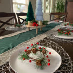 modern red and blue Christmas dining table with mini wreath place settings