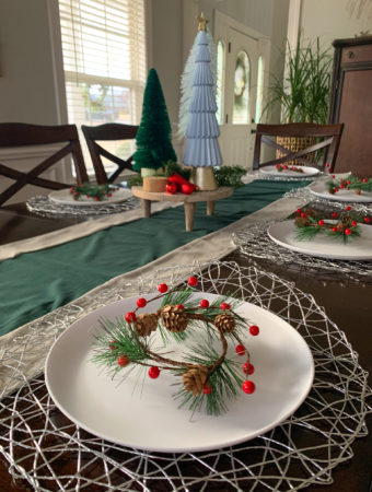 modern red and blue Christmas dining table with mini wreath place settings