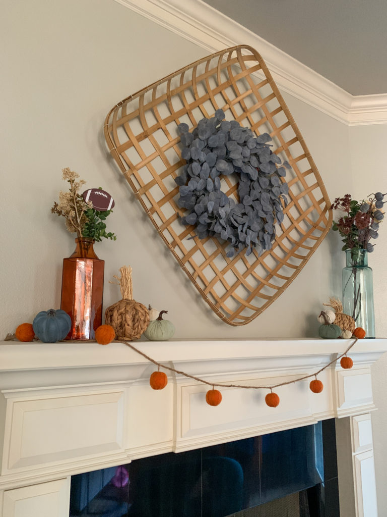 fall football decor on mantle with tobacco basket and eucalyptus wreath