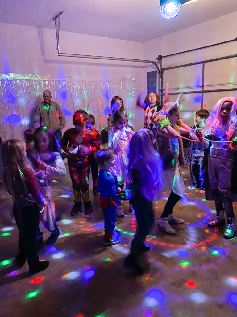 kids in Halloween costumes dancing at kids disco party