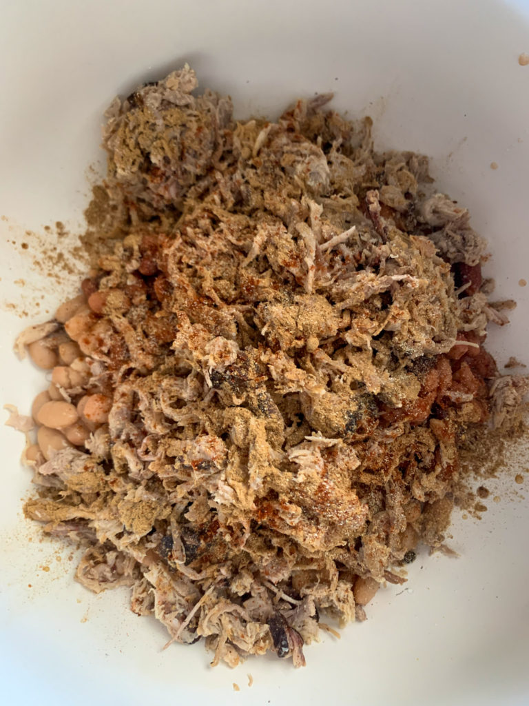 pork and beans in white pot for a pulled pork chili verde recipe