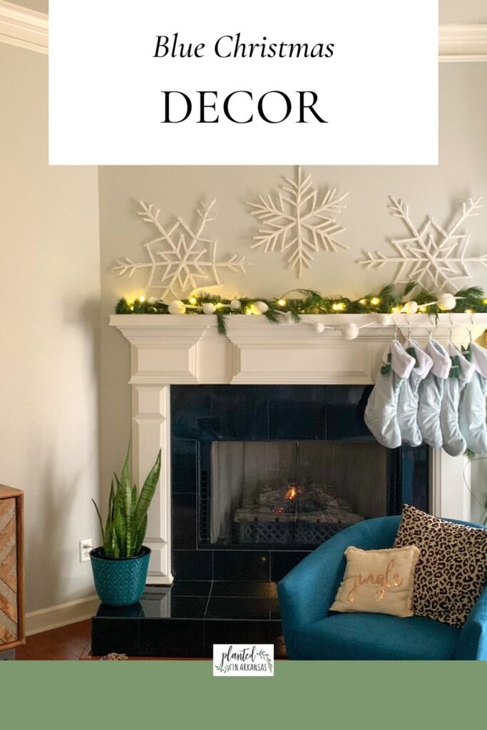 blue Christmas decorations with light blue stockings and white flocked snowflakes above mantel