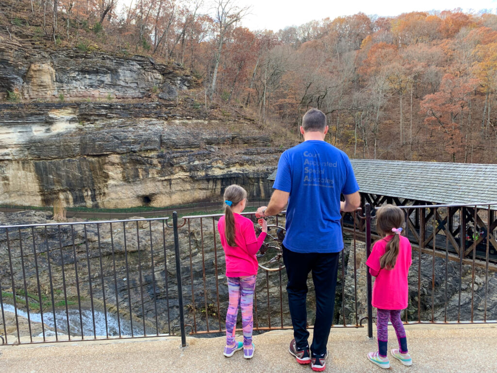 father and daughters looking at view at Big Cedar Top of the Rock 