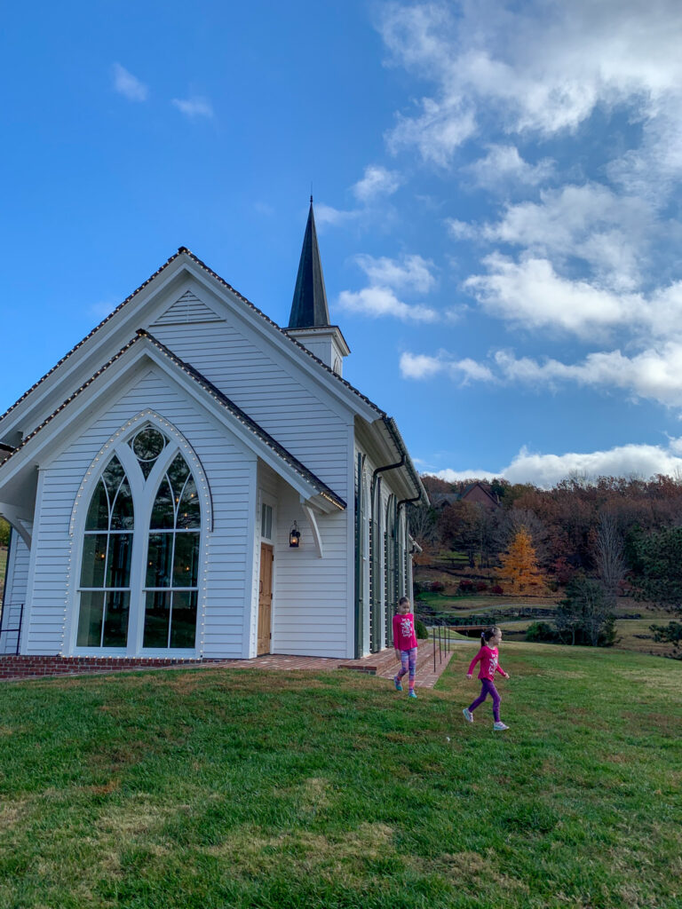 little white church at Big Cedar Lodge Resort with two little girls walking away 