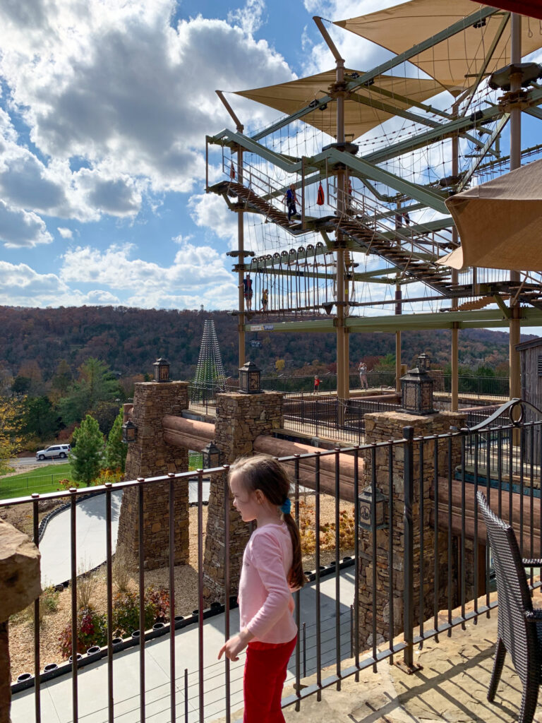 little girl stands in front of the ropes course at Fun Mountain in Branson Missouri