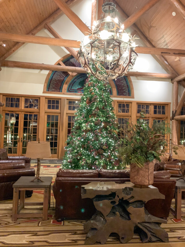 a large Christmas tree in the lobby of Falls Lodge at Big Cedar Lodge