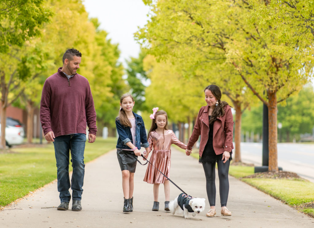 family walks dog in family photos with dog in downtown Little Rock