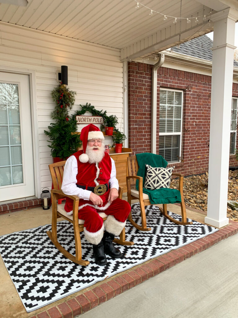 Santa Pete sits on a back porch in Arkansas as part of a neighborhood Santa visit