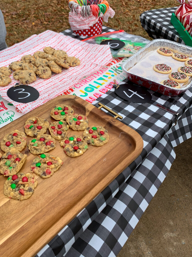 Christmas cookie bake off table with trays of cookies and numbered signs