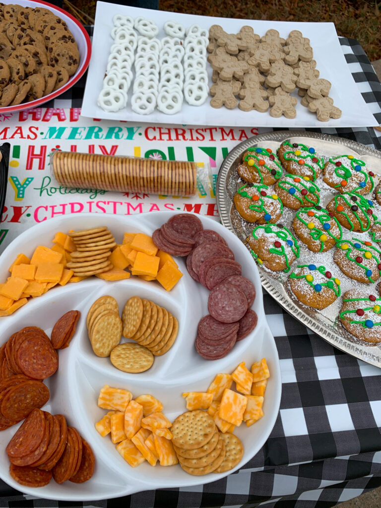a table of snacks at a neighborhood Christmas cookie bake off event