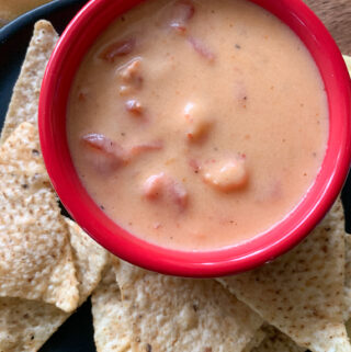 small bowl of spicy crawfish dip in the center of chips