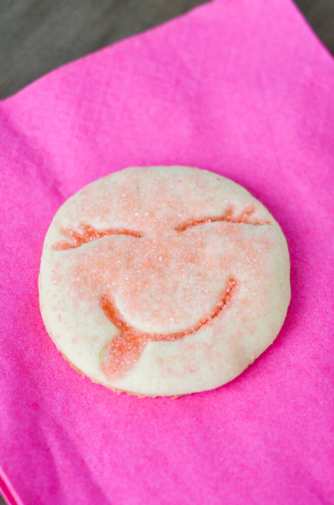 smiley face cookie on pink napkin