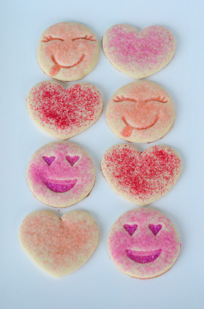pink smiley face cookies and pink sugar cookies lined up on platter for Valentine's Day
