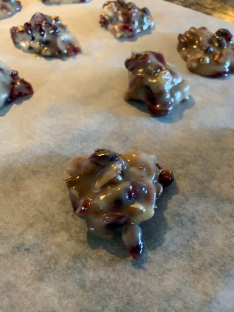 no bake cranberry pecan praline cookies setting up on parchment 