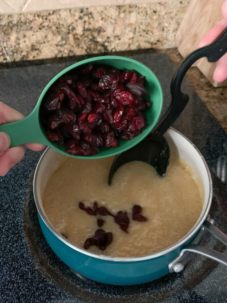 cranberries going into mixture for no bake cranberry cookies