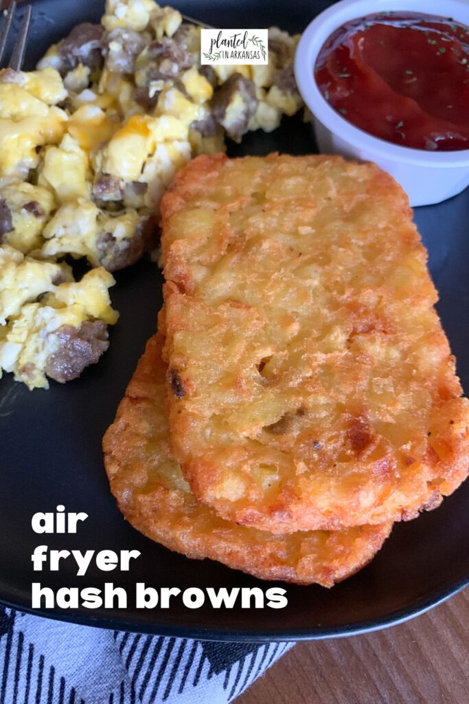 air fryer hash brown patties on black plate with eggs and ketchup and a text overlay