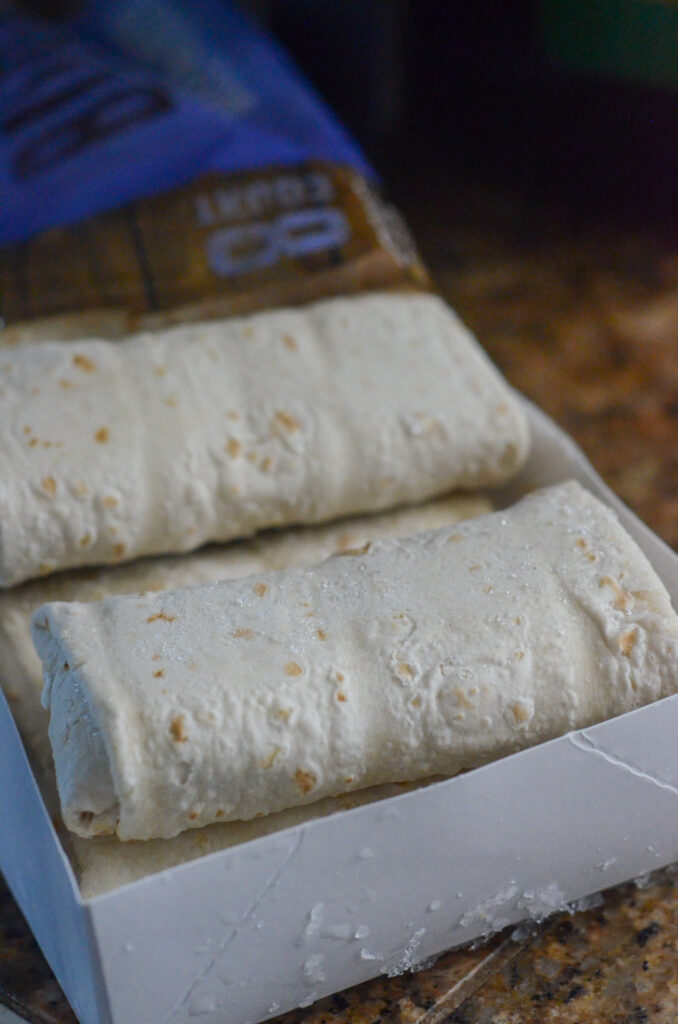 frozen El Monterey burritos in a white carton on the counter