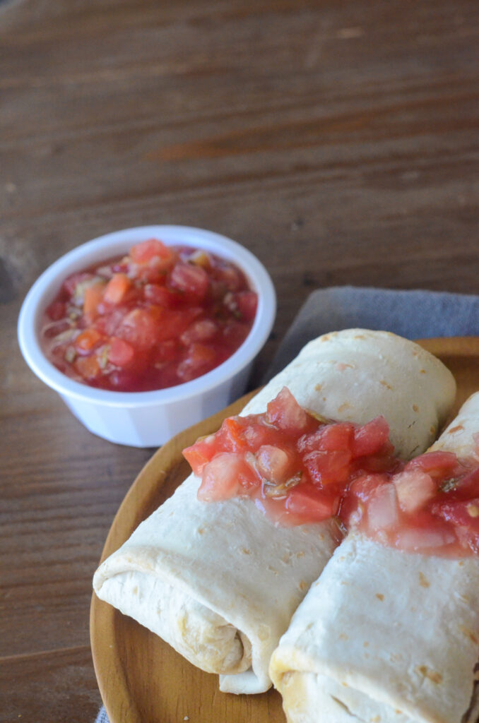 plate of frozen El Monterey air fryer burritos with a cup of salsa beside