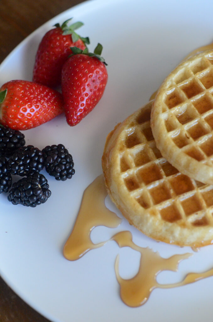 fresh berries and air fryer Eggo waffles on white plate