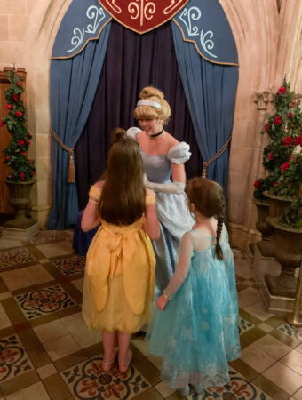 Cinderella at Cinderella's Royal Table talks with two girls in princess dresses
